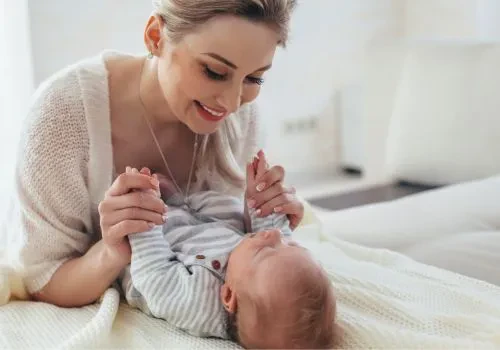 A new mom playing with her newborn